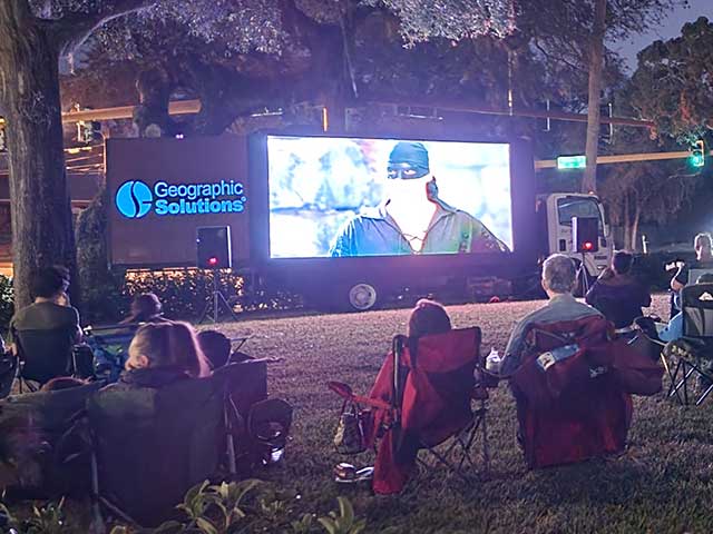 In this picture, our employees are camped out on the lawn for family movie night.