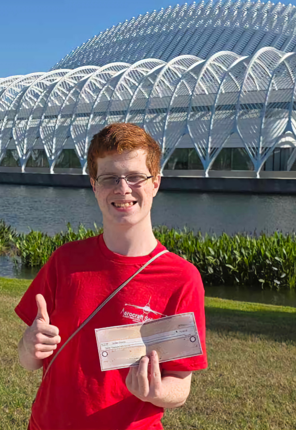 Quillen Shields holding IT Scholarship Award check