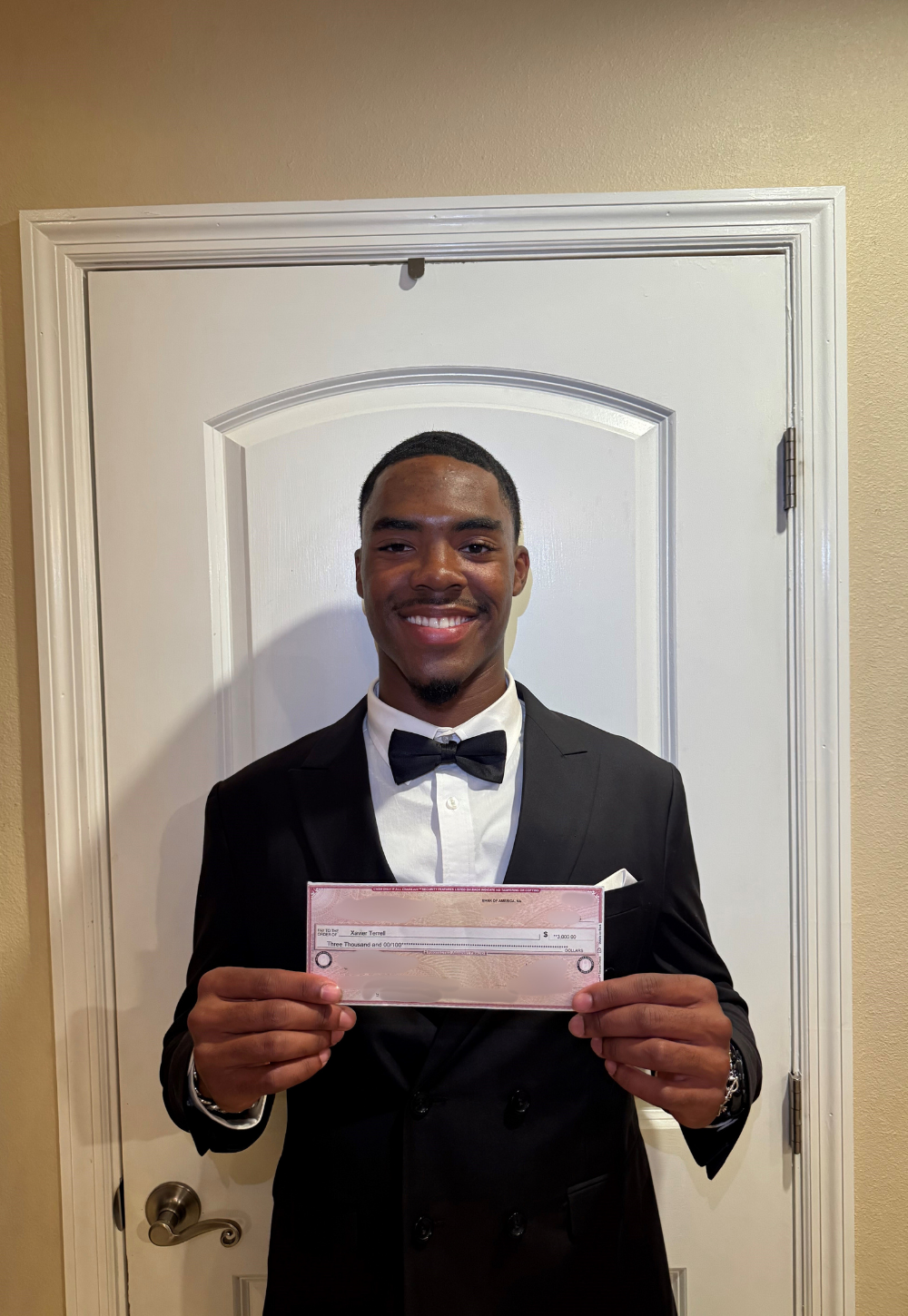 Xavier Terrell holding IT Scholarship Award check
