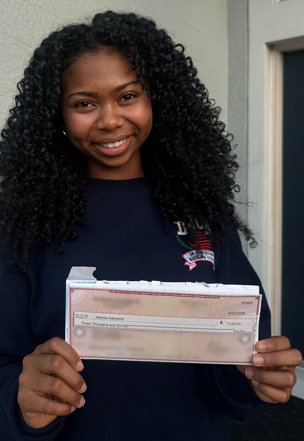 Quillen Shields holding IT Scholarship Award check