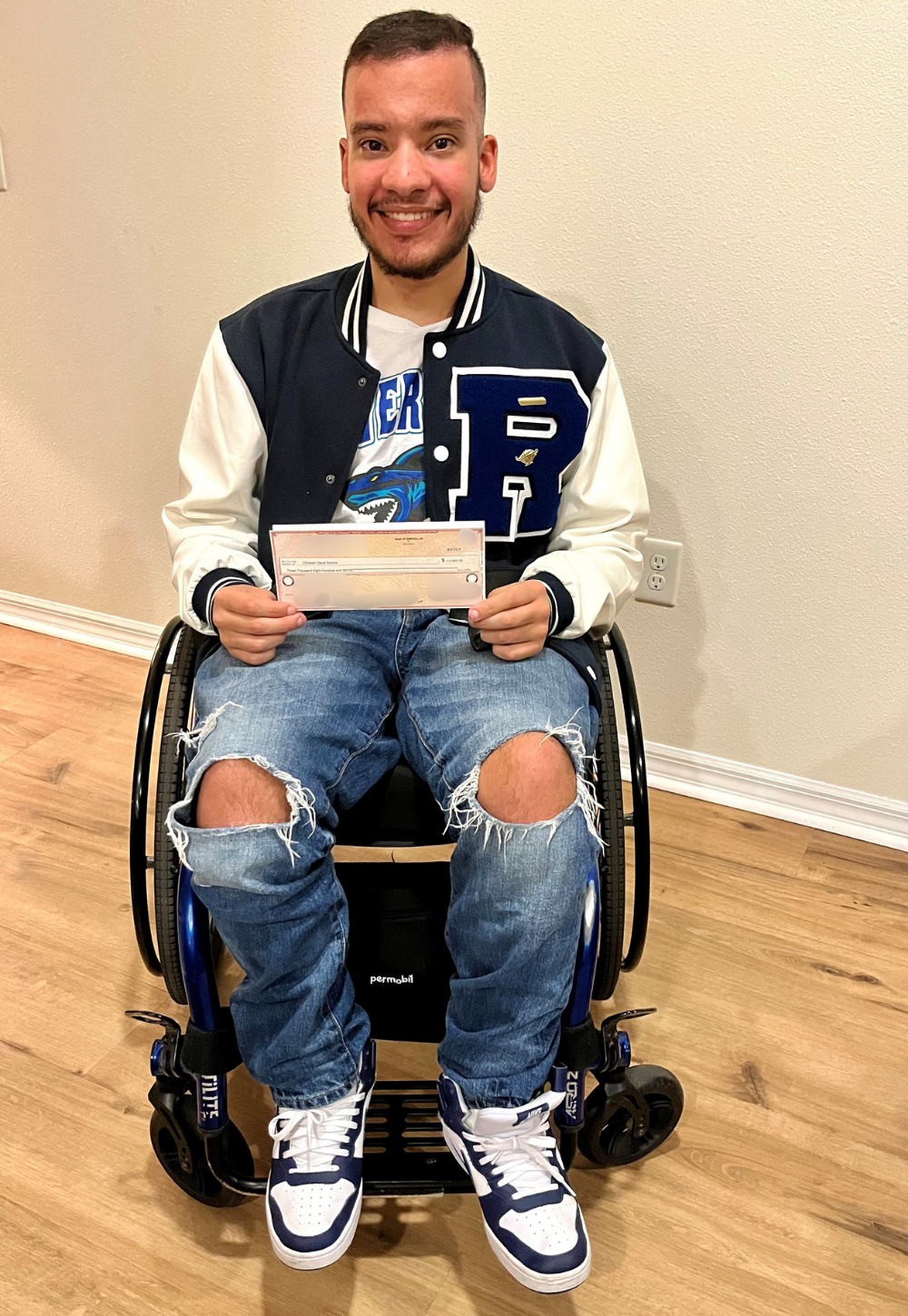 Christian Ramos holding IT Scholarship Award check