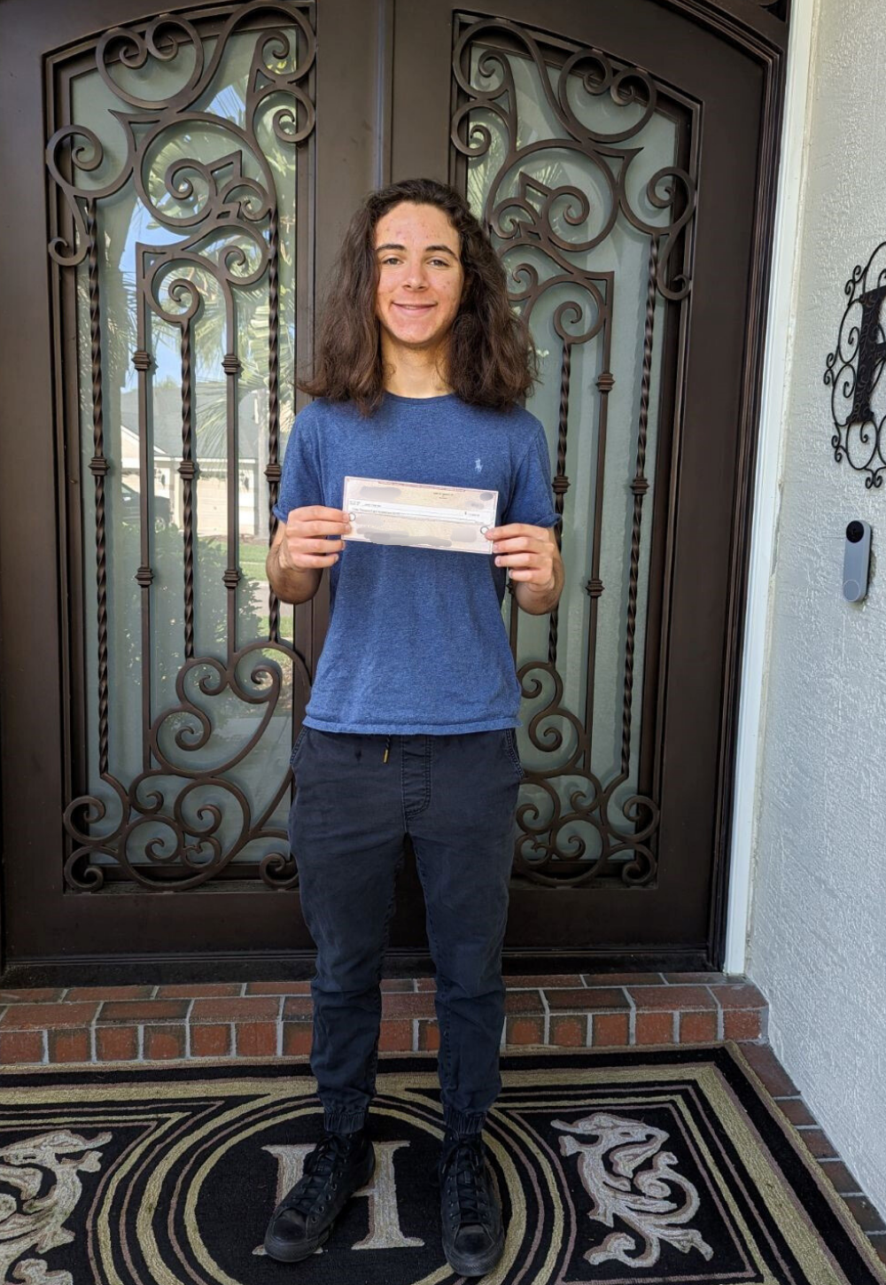 Justin Heyman holding IT Scholarship Award check