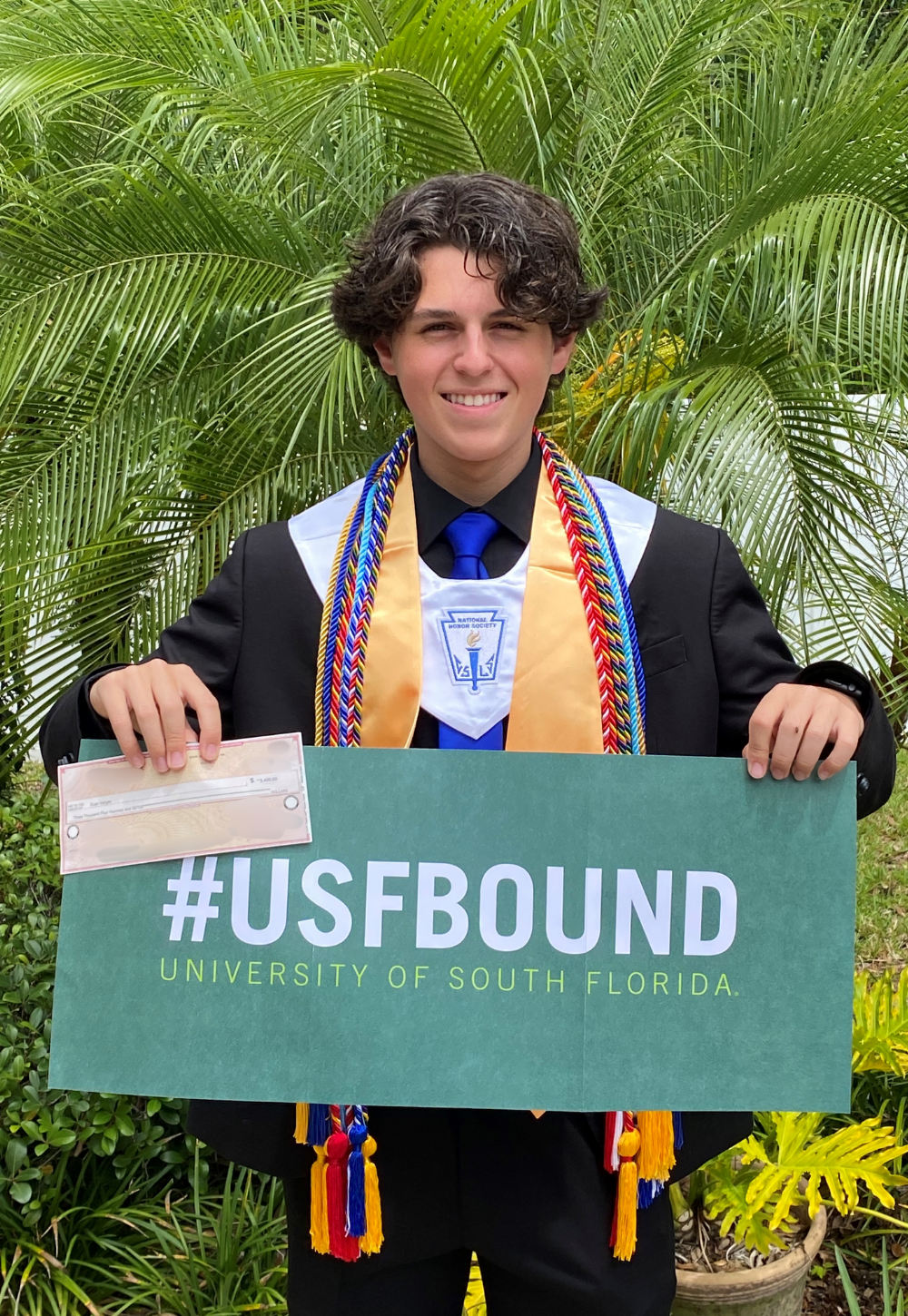 Evan Vargas holding IT Scholarship Award check