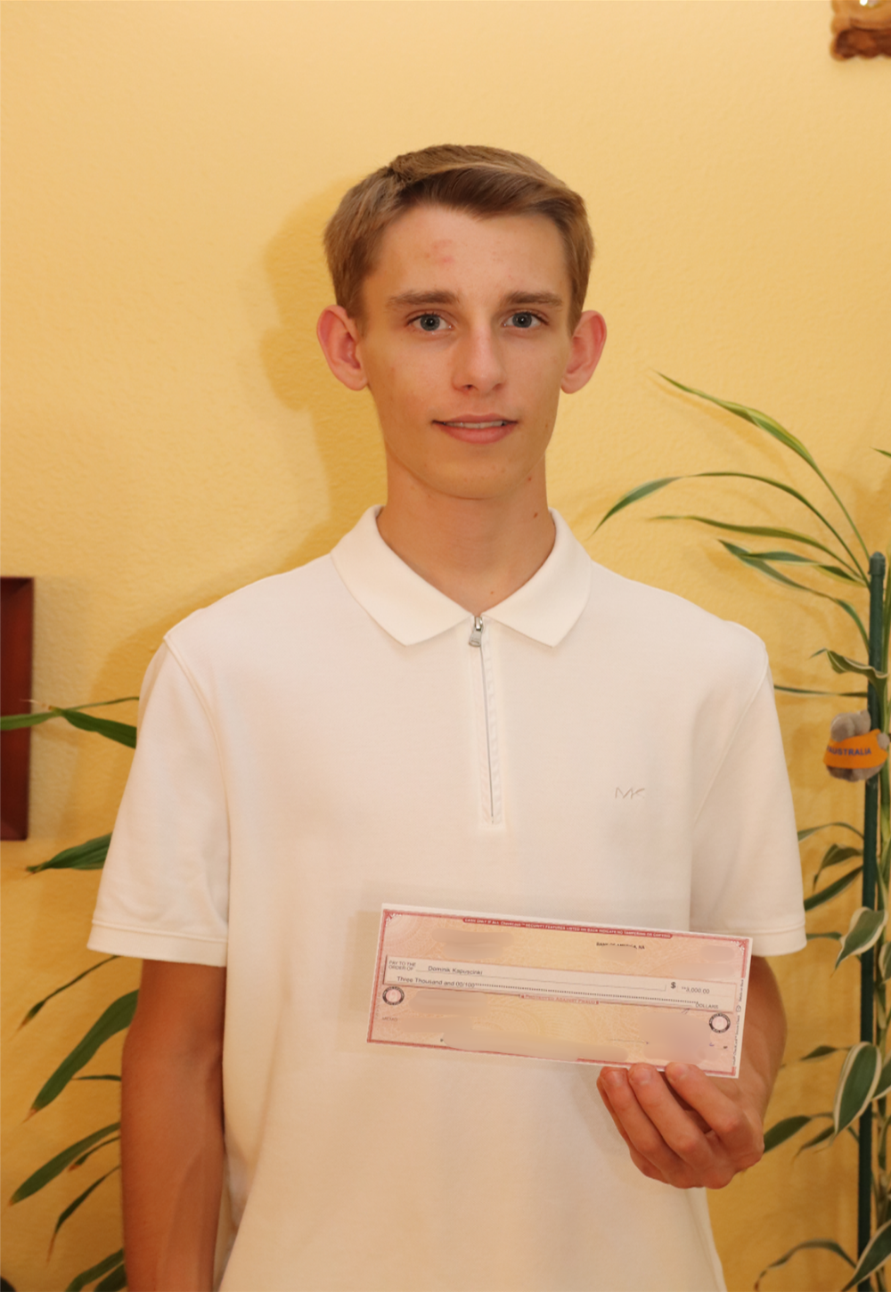 Dominick Kapuscinski holding IT Scholarship Award check