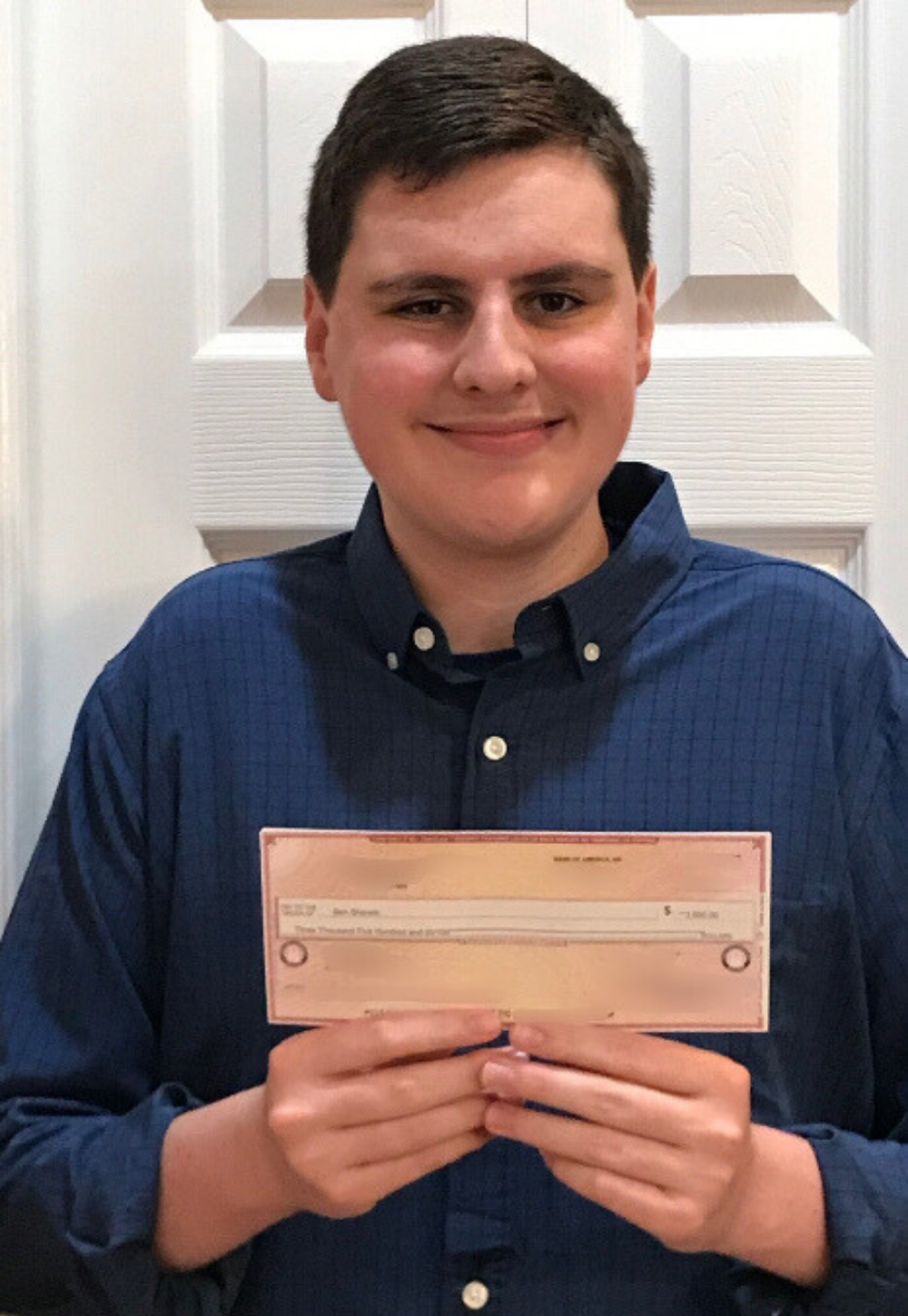 Ben Sherwin holding IT Scholarship Award check