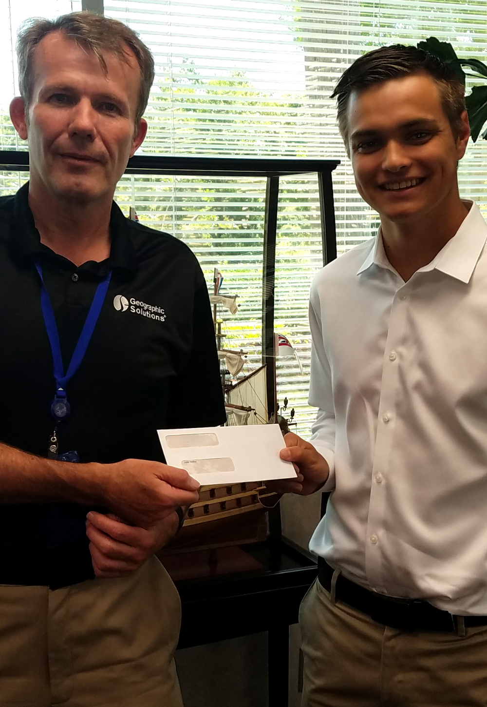Justin S. Walker with President Paul Toomey holding IT Scholarship Award check