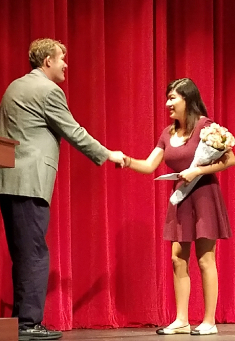 Madeleine Smiley shaking hands with President Paul Toomey while accepting IT Scholarship Award