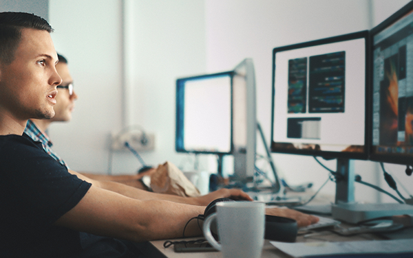 In this image, job seekers use a computer to find careers.