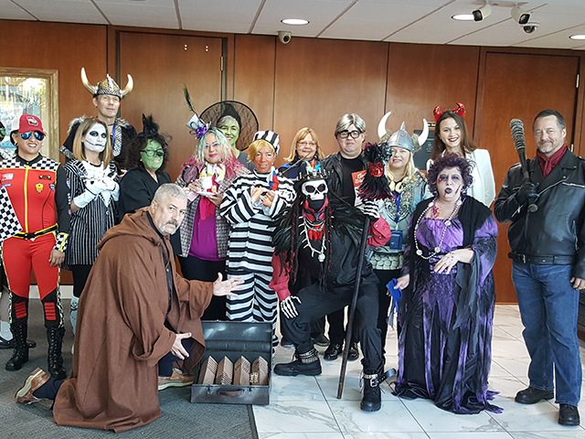 In this picture, our employees are posing for a picture dressed up in Halloween Costumes at our Coral Landings location.
