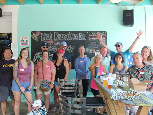 In this picture, a group of employees connect for happy hour and social gathering.