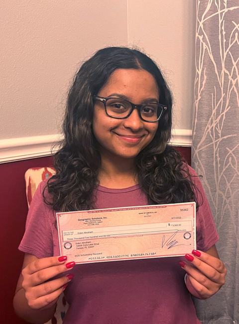 Eden Abrahams holding IT Scholarship Award check