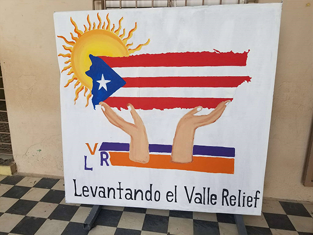 In this picture, a sign in Puerto Rico identifies a relief organization. After Hurricane Maria, Geographic Solutions sent employees to help with the relief effort.
