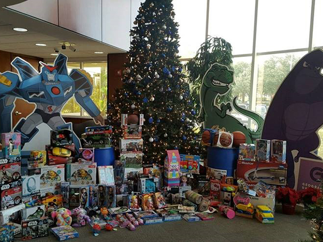 In this picture, donations for Metropolitan Ministries are positioned next to a Christmas tree in the lobby of our Coral Landings location.