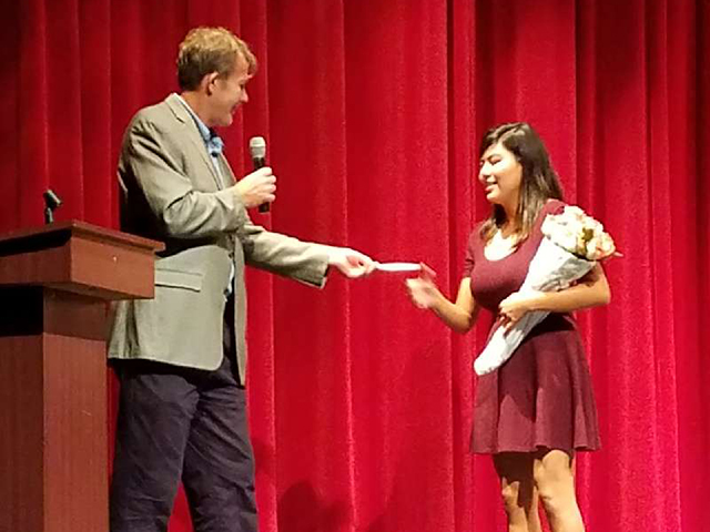 In this picture, Geographic Solutions’ president, Paul Toomey, presents a student with the Paul Toomey IT Scholarship.