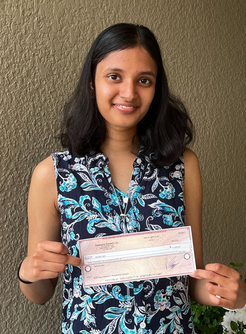 Aarushi Jain holding IT Scholarship Award check