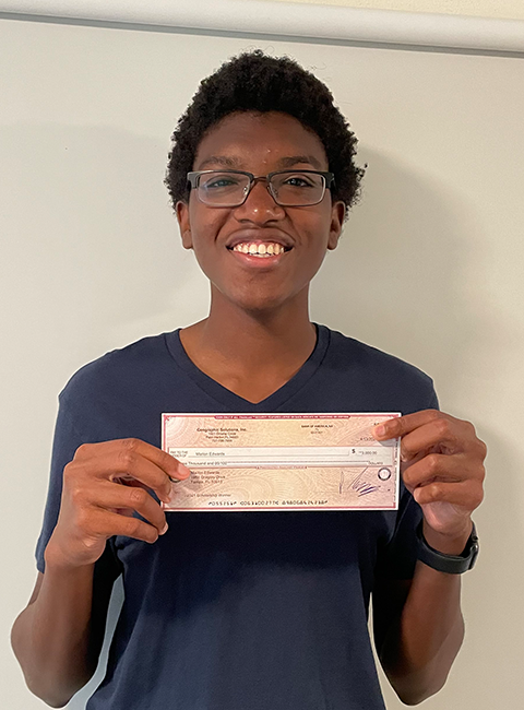 Marlon Edwards holding IT Scholarship Award check