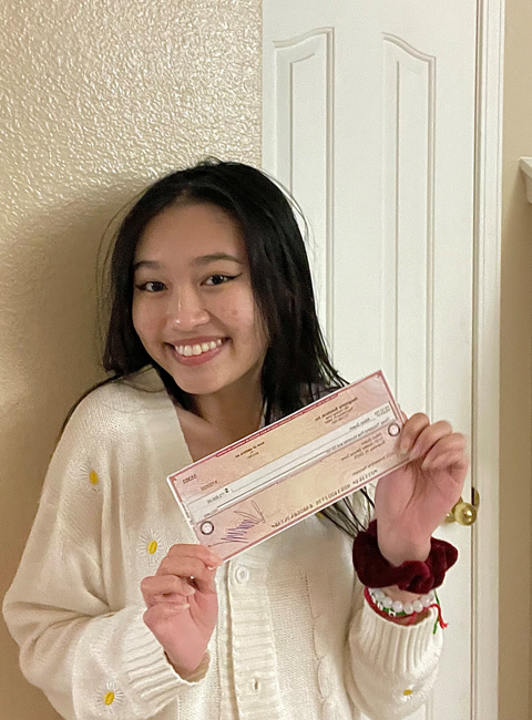 Ali Quach holding IT Scholarship Award check