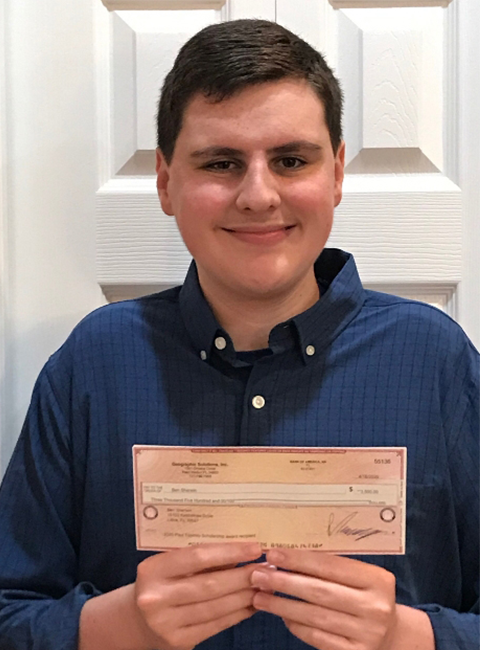 Ben Sherwin holding IT Scholarship Award check