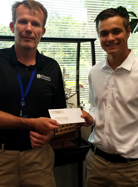 Justin S. Walker with President Paul Toomey holding IT Scholarship Award check